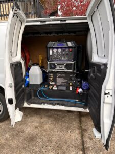 Professional carpet cleaning equipment loaded in a service van, ready for jobs by Pacific Steam Carpet Cleaning in Gresham, OR.