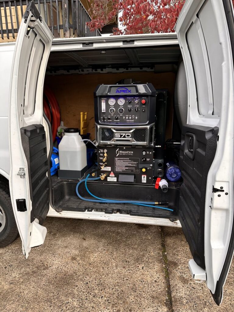 Professional carpet cleaning equipment loaded in a service van, ready for jobs by Pacific Steam Carpet Cleaning in Gresham, OR.