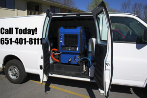A white service van with its doors open, revealing professional carpet cleaning equipment inside for stpaulbestcarpetcleaners.com in Saint Paul, MN.