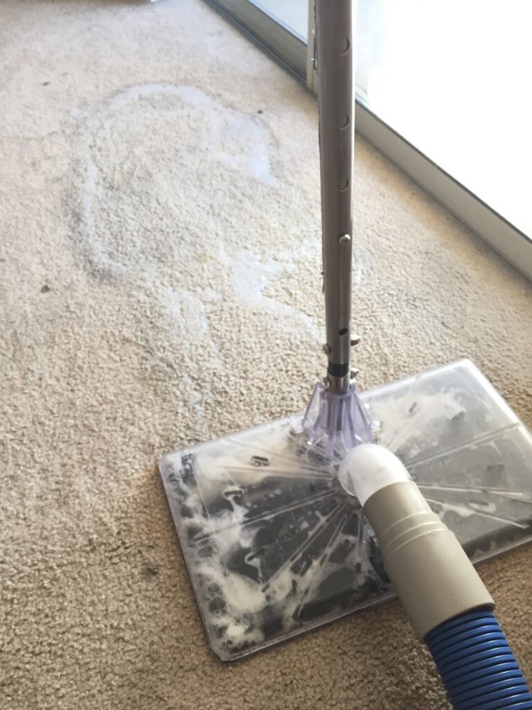 A carpet cleaning extraction tool removing dirty water from a carpet by Spectrum Cleaning & Restoration in Medford, OR