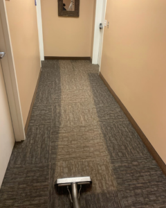 A carpet cleaning wand in a hallway, showing a clean path at Fusioncarpetcleaning in Fort Walton Beach, FL