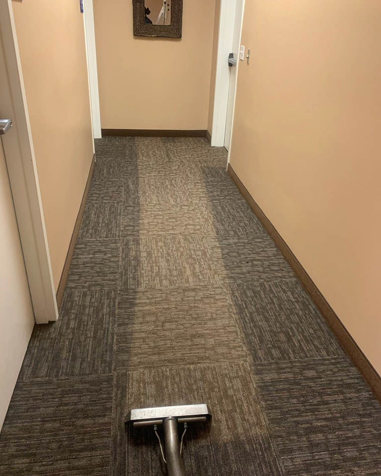A carpet cleaning wand in a hallway, showing a clean path at Fusioncarpetcleaning in Fort Walton Beach, FL