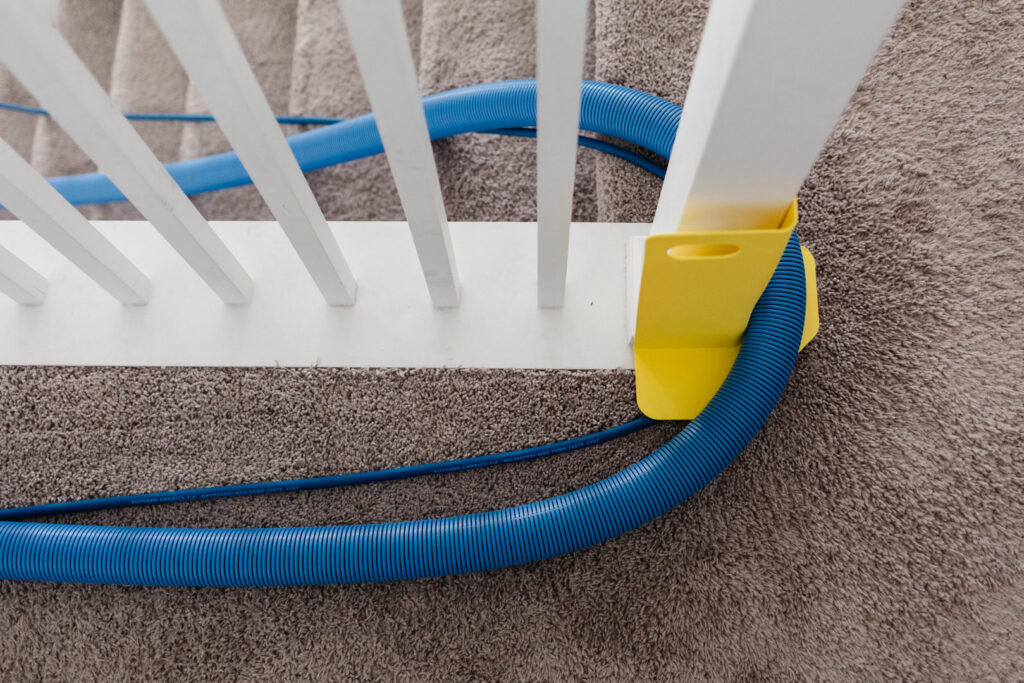Carpet cleaning hoses protected on stairs during a service by Zerorez Greenville, SC.