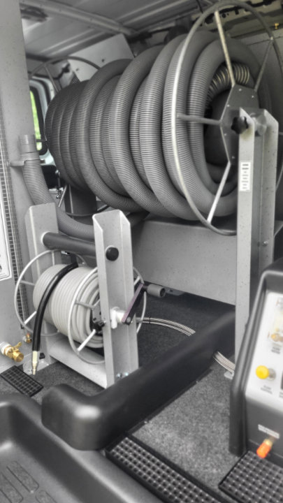 Hose reels for professional carpet cleaning equipment inside a service van for My Carpet Cleaner Nashville, TN