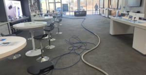 Carpet cleaning hoses extending across a commercial space during a job by Leiter's Carpet Cleaning in Fort Wayne, IN.