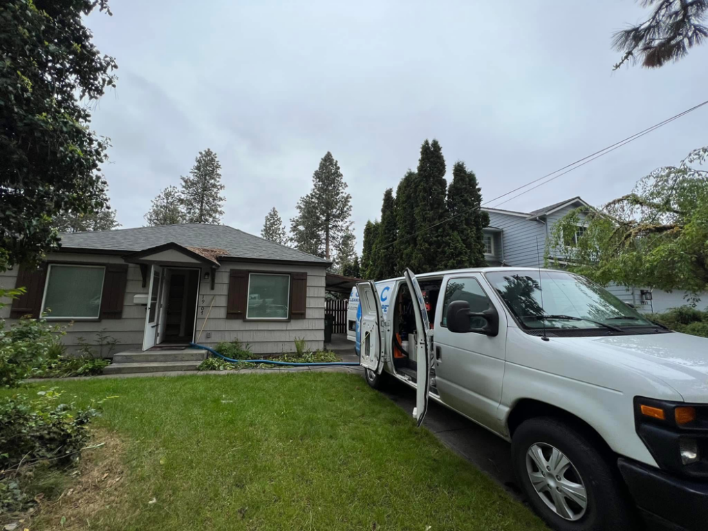 Carpet cleaning hoses from the C & C Carpet Cleaning van entering a client's home in Spokane, WA, for a job.