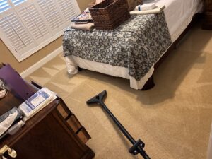 A carpet cleaning tool on a beige bedroom carpet, showing a clean path next to an uncleaned area by Zerorez Columbia in Columbia, SC.