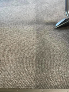 A carpet cleaning machine creating a clean path on a dirty carpet at Baymist Carpet Cleaning & Repair in Spokane, WA.