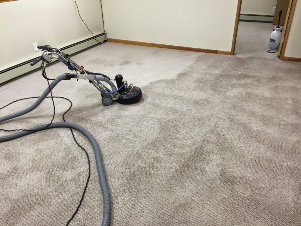 A carpet cleaning machine showing the clear difference between cleaned and uncleaned carpet by Alaska Floor Care Specialists in Fairbanks, AK.