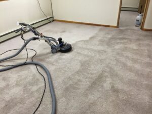 A carpet cleaning machine showing the clear difference between cleaned and uncleaned carpet by Alaska Floor Care Specialists in Fairbanks, AK.