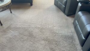 A carpet cleaning machine creating a clean path on a light-colored carpet by Atlanta Top Force Carpet Cleaning in Roswell, GA.