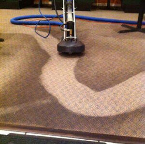 A carpet cleaning machine actively cleaning a carpet, showing the before and after, by Cobb Carpet Supply in Dallas, TX