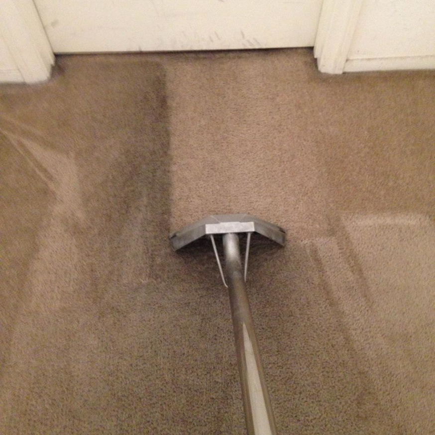 A professional carpet cleaning service in progress, showing a clean path next to a dirty area by Details Carpet and Tile Care in Las Vegas, NV.