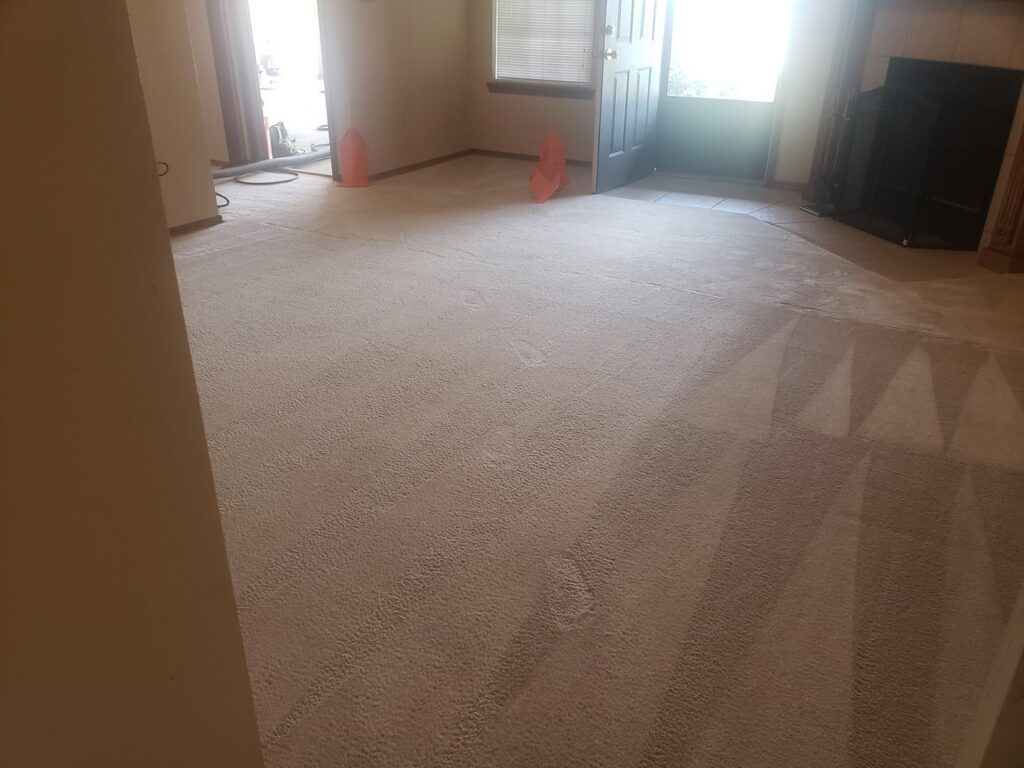 Carpet cleaning in progress with equipment visible in a home by A Plus Carpet Cleaning in Lawton, OK.