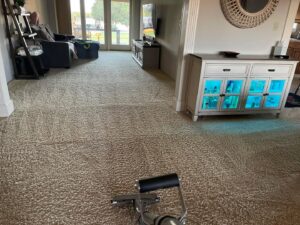 A carpet cleaning wand in use on a light brown carpet by Floor Medics in Huntsville, AL