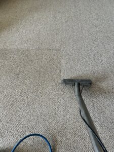 Carpet cleaning in progress, showing a wand cleaning a carpet for Let George Do It Carpet Cleaning in Omaha, NE.