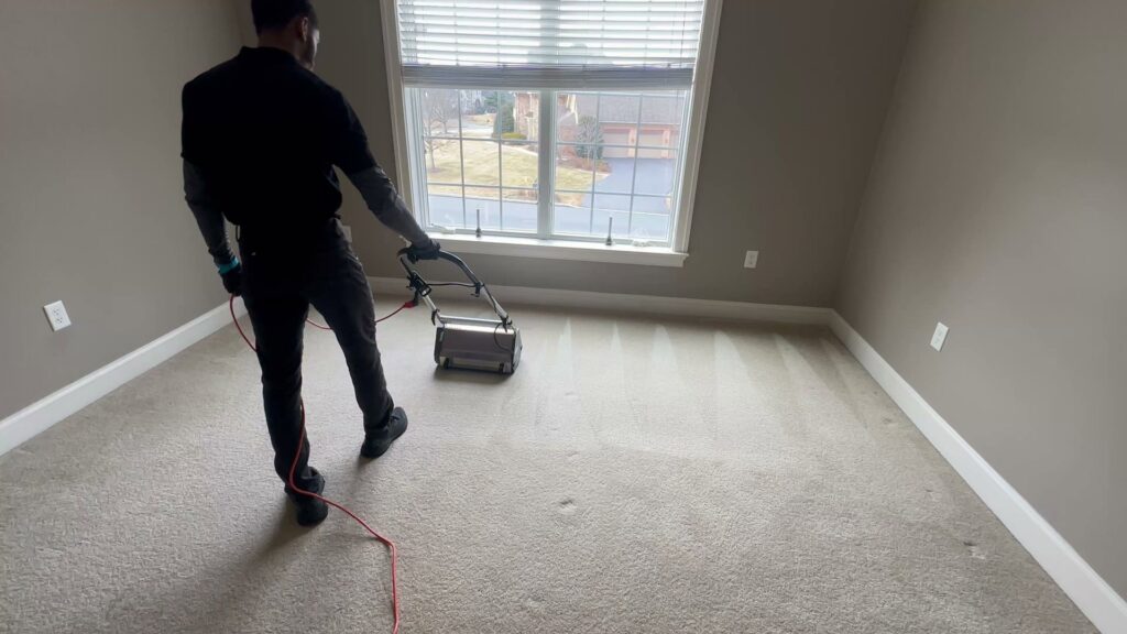 A professional from LHB Clean Team performing carpet cleaning services in a residential room in Harrisburg, PA.
