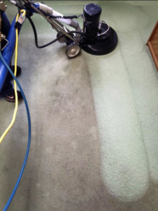 A carpet cleaning machine actively cleaning a carpet, showing clean and dirty sections, by Jet Steam Carpet Cleaning in Sitka, AK.