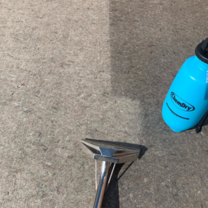 A carpet cleaning in progress, showing a clean and dirty section with equipment from Precision Chem-Dry Of DFW in North Richland Hills, TX.