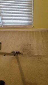 A carpet cleaning wand in action, showing a dirty carpet being cleaned by Affordable carpet cleaning CO LLC in Montgomery, AL.