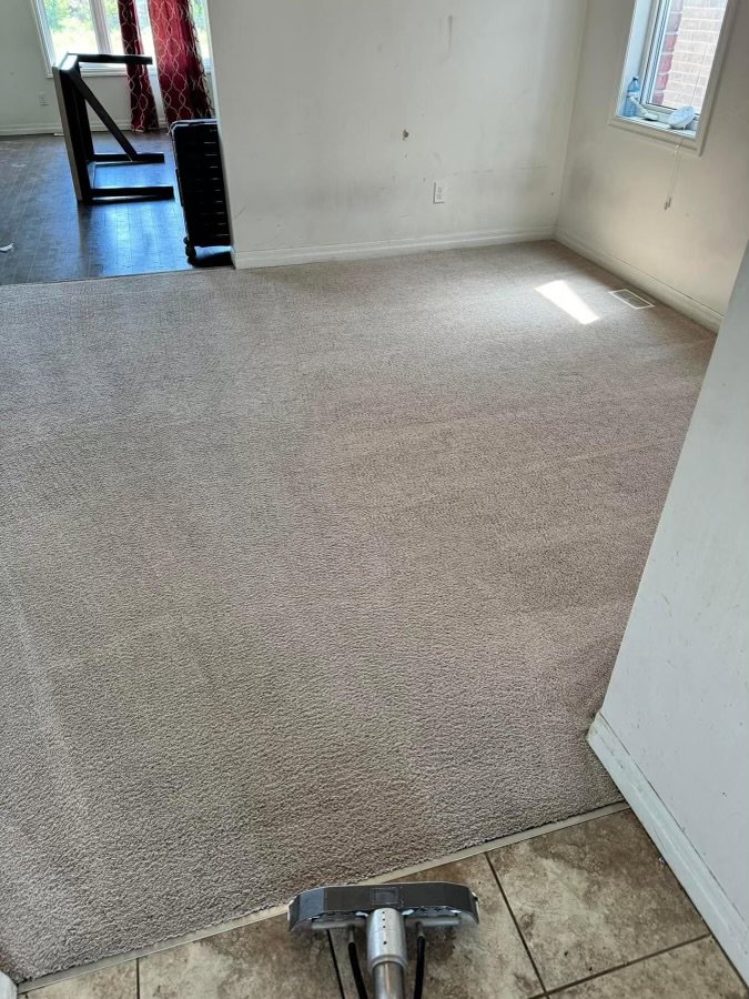 A carpet cleaning wand in action, showing a clean path on a dirty carpet by Humble Brothers Carpet Cleaning in Durham, NC.
