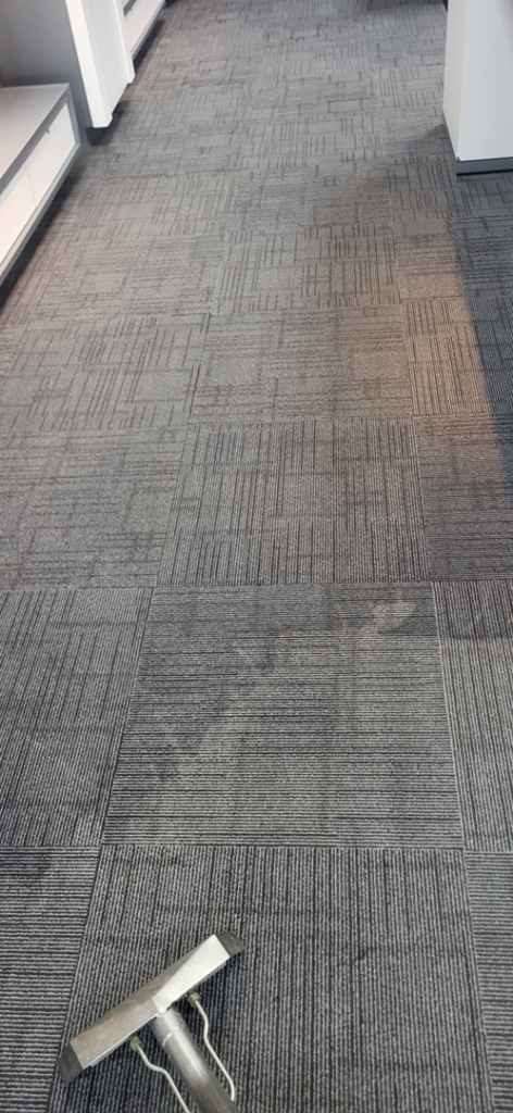 A carpet cleaning wand in use on commercial carpet tiles during a job by Leiter's Carpet Cleaning in Fort Wayne, IN.