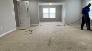 A professional performing carpet cleaning in a residential room for Winston Salem Carpet Cleaning by Hernandez in Greensboro, NC.