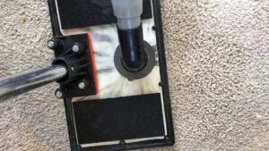 A professional carpet cleaning tool working on a dirty carpet, showing a clean path at Zerorez Charlotte, NC.