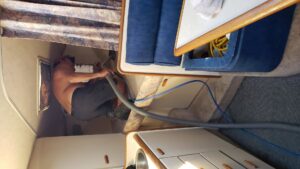 A technician from Anderson Certified, INC. performing carpet cleaning inside a boat in Chicago, IL.