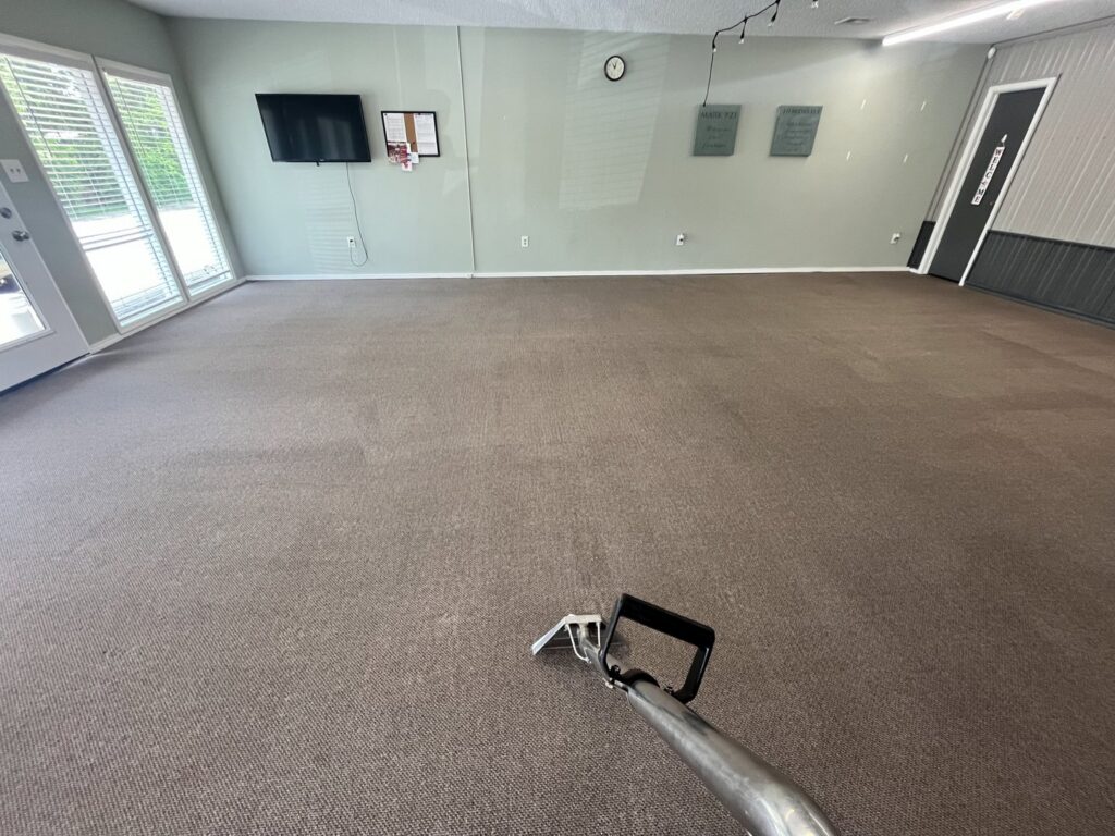 A professional carpet cleaning service in progress in a large room by The Floor Care Guys in Bentonville, AR.