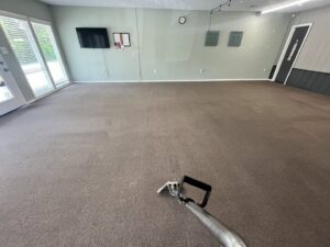 A professional carpet cleaning service in progress in a large room by The Floor Care Guys in Bentonville, AR.