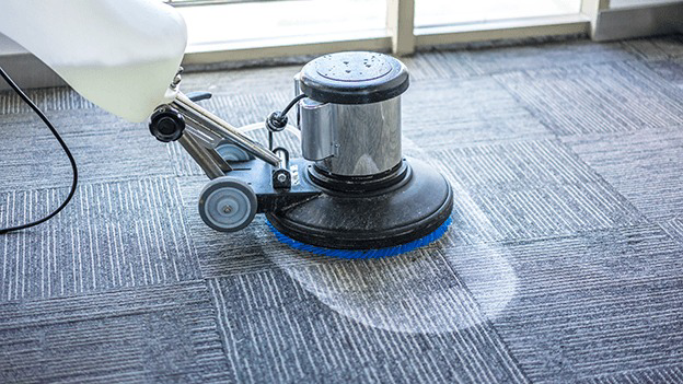 A professional carpet cleaning machine in action on a patterned carpet by 864 Cleaning & More in Greenville, SC.