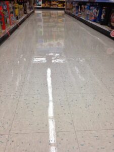 A professional carpet cleaning machine in action, leaving clean streaks on a beige carpet by DW Facility Services LLC in Brooklyn Center, MN