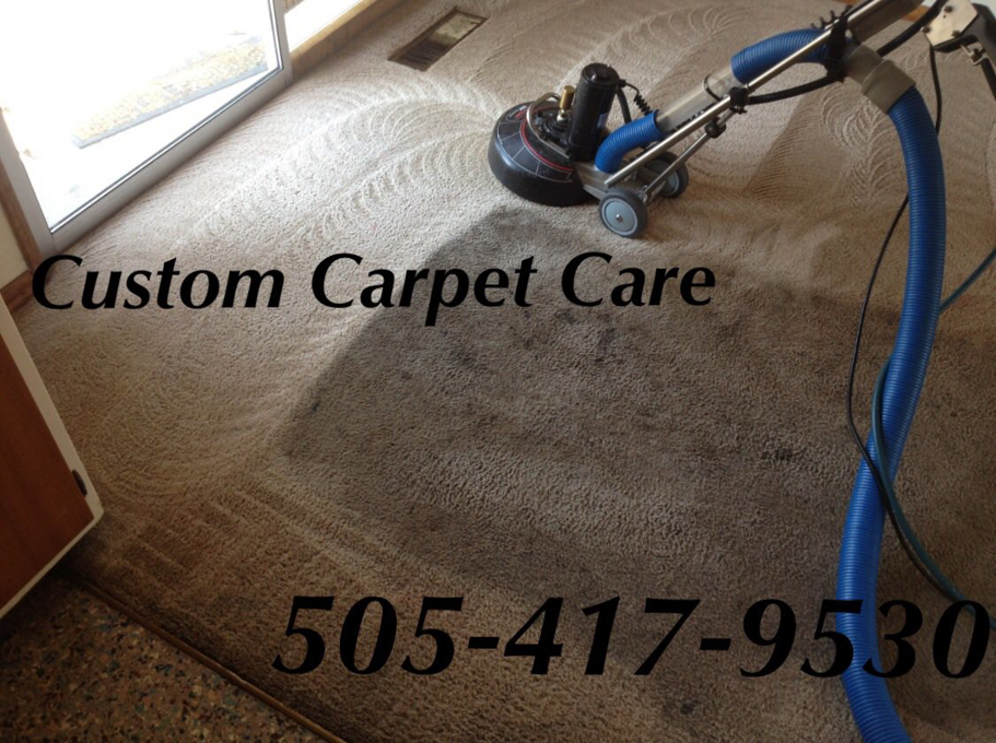 A carpet cleaning machine in action, showing a clean path on a residential carpet by Custom Carpet Cleaning in Albuquerque, NM.