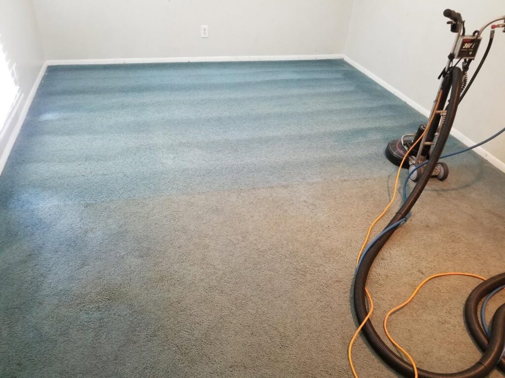 A professional carpet cleaning machine in action, showing a clean strip next to a dirty area by D&H Anytime Carpet Cleaning LLC in Mobile, AL.
