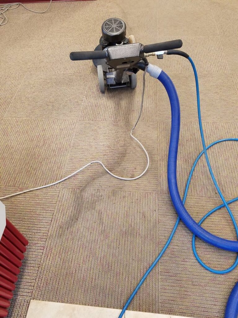 A professional carpet cleaning machine in action on a commercial carpet, provided by Exceptional Carpet Care in Rochester, MN.