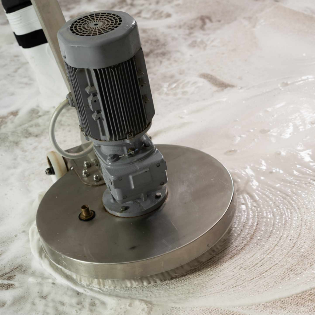 A professional carpet cleaning machine actively cleaning a carpet with foam at Fantastic Carpet Cleaning NYC in Ridgewood, NY