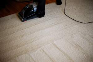 Carpet cleaning machine actively cleaning a light-colored carpet, showing clean stripes, by Philadelphia Carpet Cleaning Co, Lansdowne, PA.