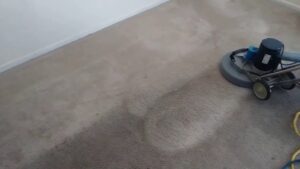 A professional carpet cleaning machine actively cleaning a dirty carpet by Raysco, Inc. in Las Vegas, NV.