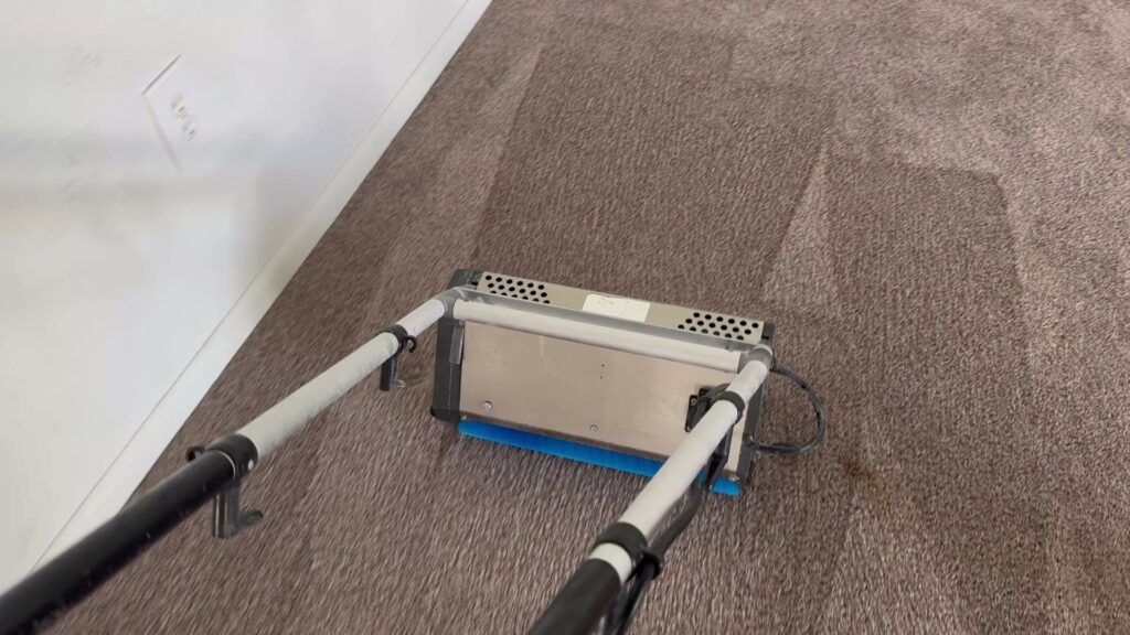 A professional carpet cleaning machine in action, cleaning a carpet for Rent A Vet Carpet Cleaning in St. Charles, MO.