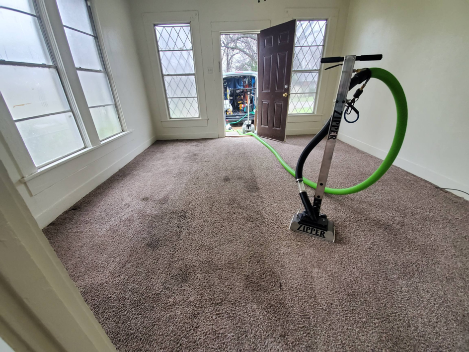 A professional carpet cleaning machine in action, cleaning a room by Rug-Ratz professional carpet cleaner in Shreveport, LA