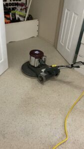 A carpet cleaning machine in operation on a light-colored carpet in a room by Heaven's Best Carpet Cleaning in Oklahoma City, OK.