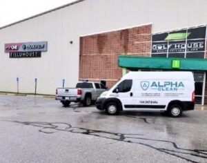 A powerful carpet cleaning machine and hoses visible inside an Alpha Clean service van in Fort Wayne, IN.
