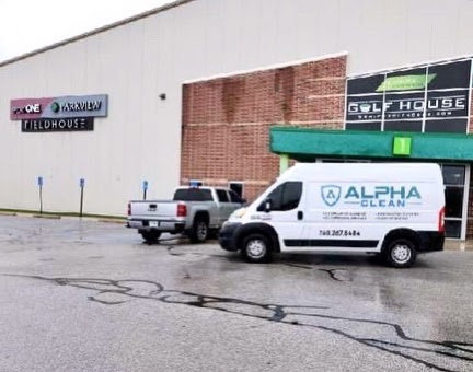 A powerful carpet cleaning machine and hoses visible inside an Alpha Clean service van in Fort Wayne, IN.