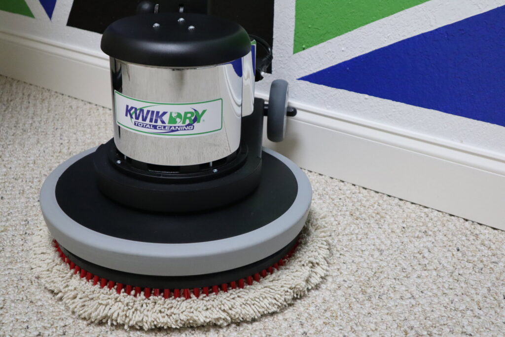 A professional carpet cleaning machine working on a light-colored carpet by Rhode Island Kwik Dry in Providence, RI.