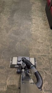 A carpet cleaning machine on a patterned carpet showing a clean path by Jones Carpet Care LLC in Huntsville, AL.
