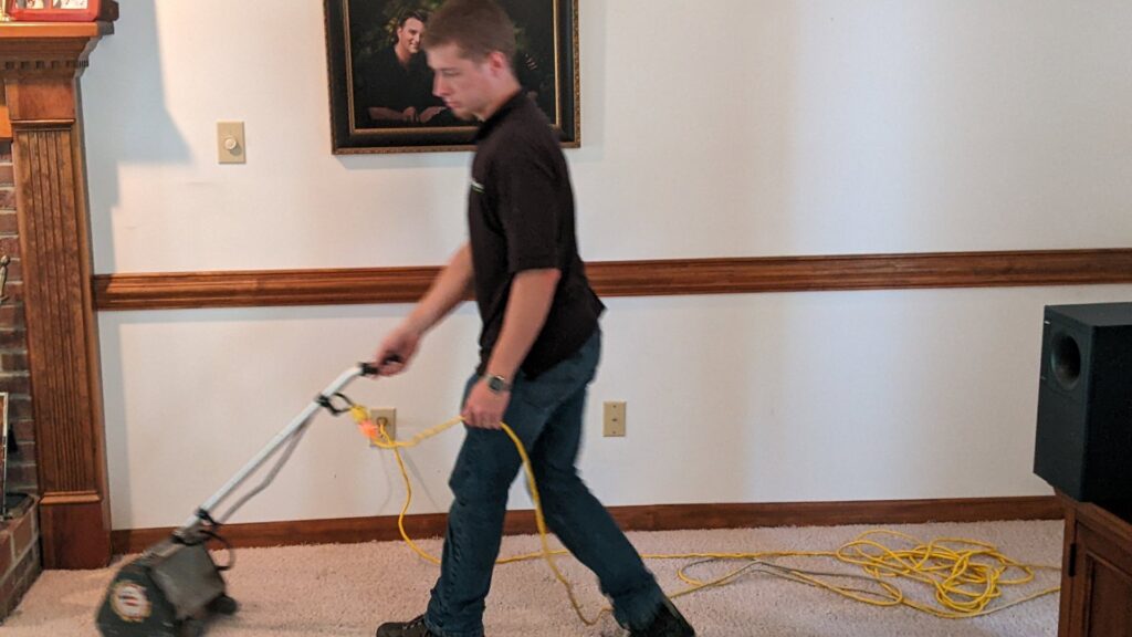 A technician operating a carpet cleaning machine for Regional Carpet Care in Garner, NC.