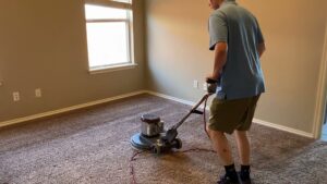 A professional operating a carpet cleaning machine on a residential carpet by Heaven's Best Carpet Cleaning in Oklahoma City, OK.