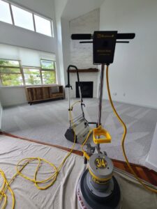 A professional carpet cleaning machine on a drop cloth in a residential living room by Select Carpet Clean LLC in Scranton, PA.