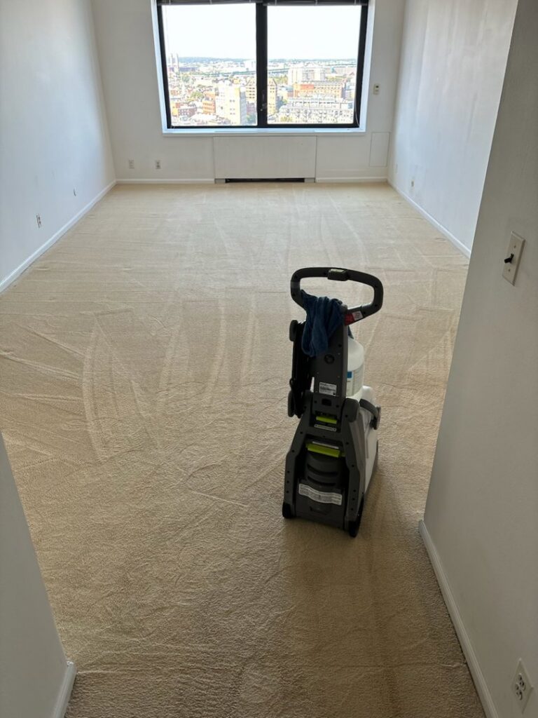 A carpet cleaning machine in a large room with freshly cleaned carpet by Ready2go Professional Carpet & Upholstery Cleaning in Boston, MA